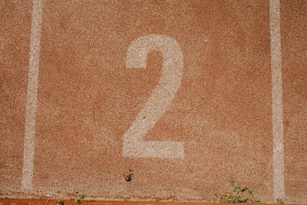 Close-up of number two on a track starting line, perfect for sports themes.